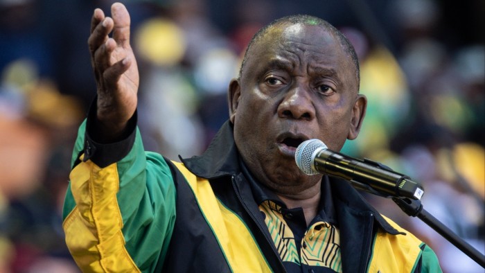 Cyril Ramaphosa addresses supporters at a podium during a rally in Johannesburg