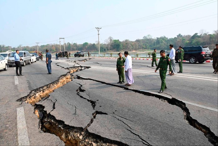 Myanmar’s military leader General Min Aung Hlaing, center left, inspects road damage in Nay Pyi Taw, the capital, following the earthquake 