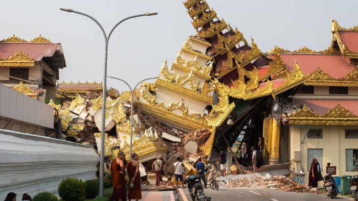 People look at the collapsed Maha Myat Muni Pagoda following an earthquake in Mandalay, Myanmar on Friday