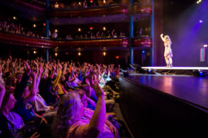 Paula Pant on stage at World Domination Summit giving a speech