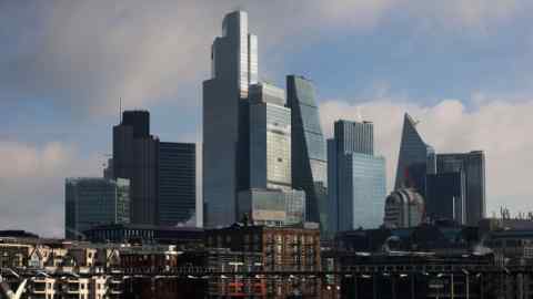 The city skyline of London, featuring a cluster of modern skyscrapers under a partly cloudy sky