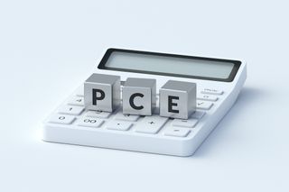 pce spelled out in silver dice on top of calculator