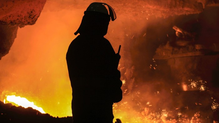 A steelworker watches as molten steel pours from one of the blast furnaces during ‘tapping’ at the British Steel - Scunthorpe plant in north Lincolnshire, north-east England