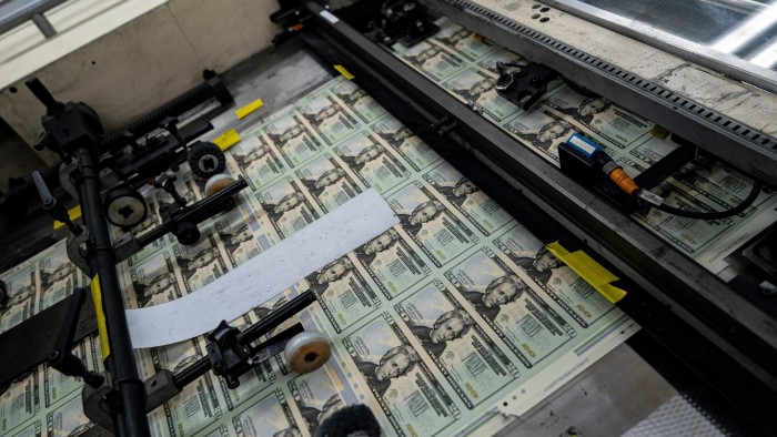 A sheet of uncut $20 bills is seen on a printing machine at the US Bureau of Engraving and Printing in Washington