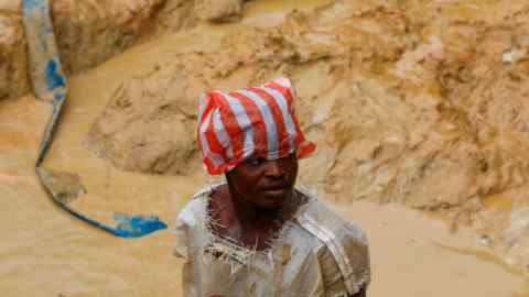 An artisanal miner searches for gold inside an excavated pit at the Prestea-Huni Valley Municipal District in the Western Region, Ghana