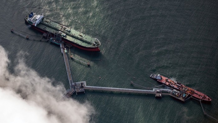 An aerial view of the tanker and another smaller vessel at the refinery