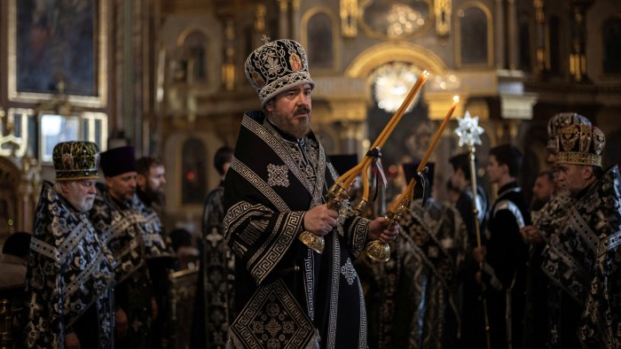 Orthodox priests take part in the Good Friday procession at Annunciation Cathedral in Kharkiv