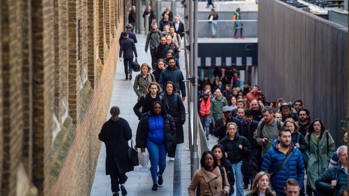 Commuters make their way into work from Liverpool Street train station in London