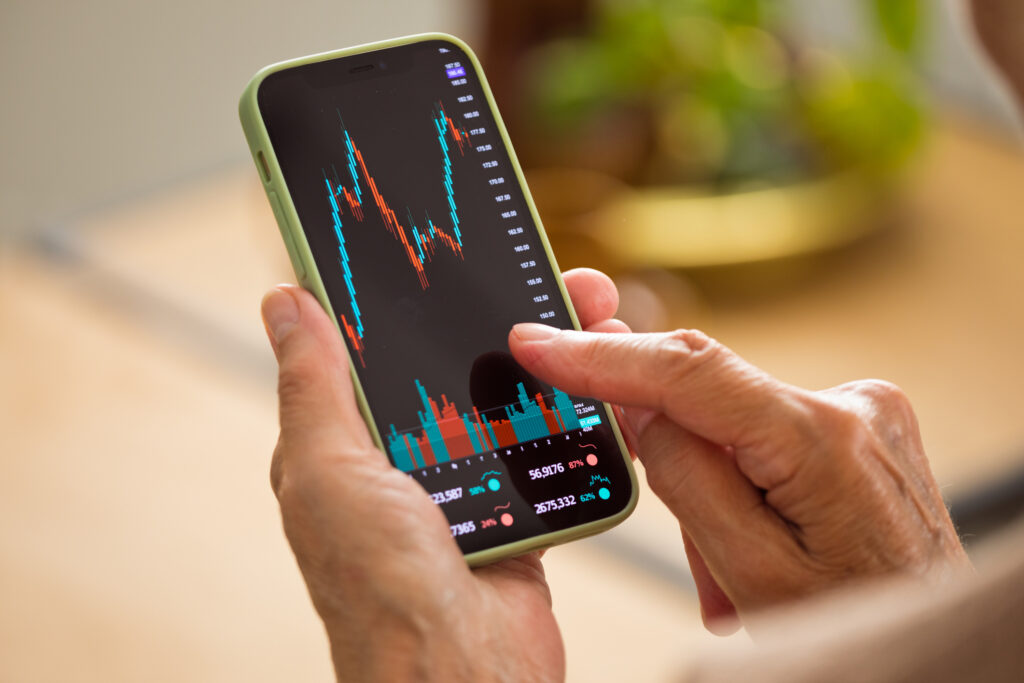 Woman using phone to check stock market activity