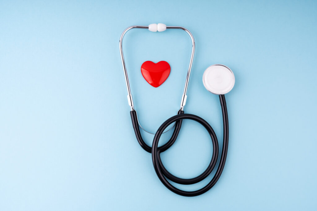 Medical Stethoscope and Heart on Blue Background Health Care Insurance Concept - stock photo