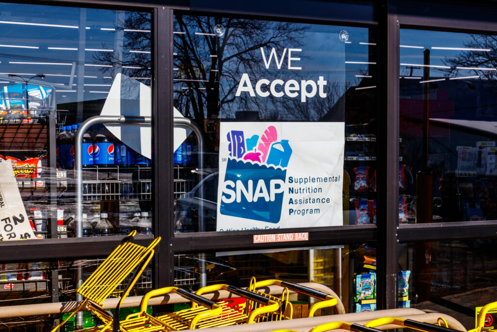 A sign at a grocery story reads - We Accept SNAP