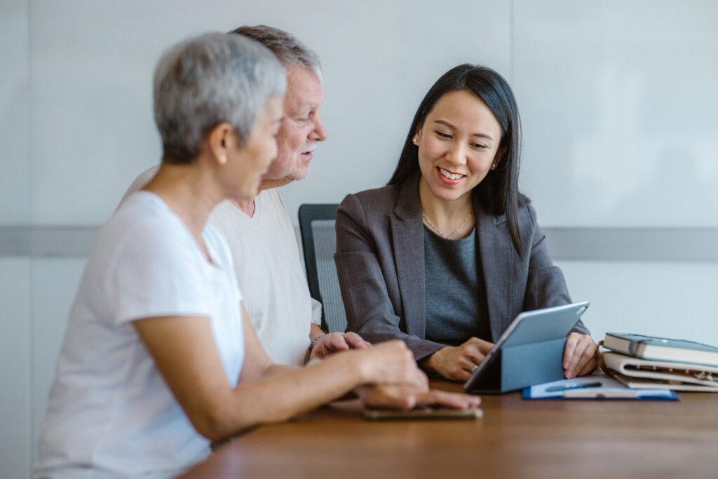 A couple is going over their life insurance policy with their insurance agent.