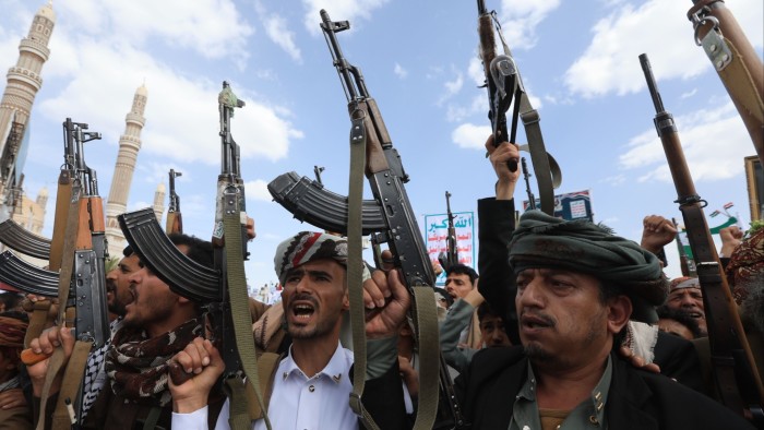 Houthi supporters shout slogans and hold up their weapons during a protest against the US in Sana’a, Yemen on April 25