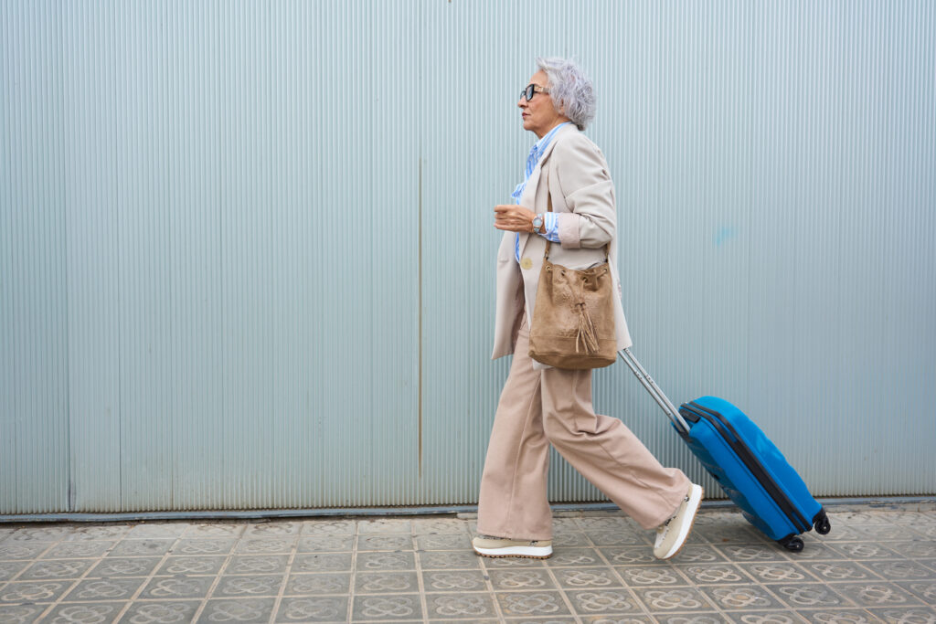 Woman dragging a suitcase toward airport