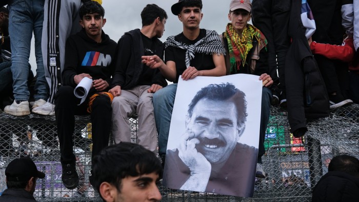 Kurdish youths with a poster of jailed PKK leader Abdullah Öcalan in Diyarbakir, south-eastern Turkey, in March