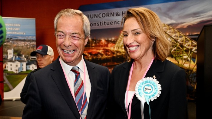 Nigel Farage and Sarah Pochin smile as they speak to the media during a vote recount