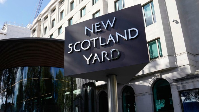 A sign stands in front of the New Scotland Yard, the headquarters of the London Metropolitan Police