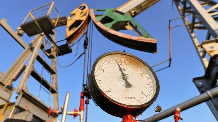 A pressure gauge near oil pump jacks in Russia