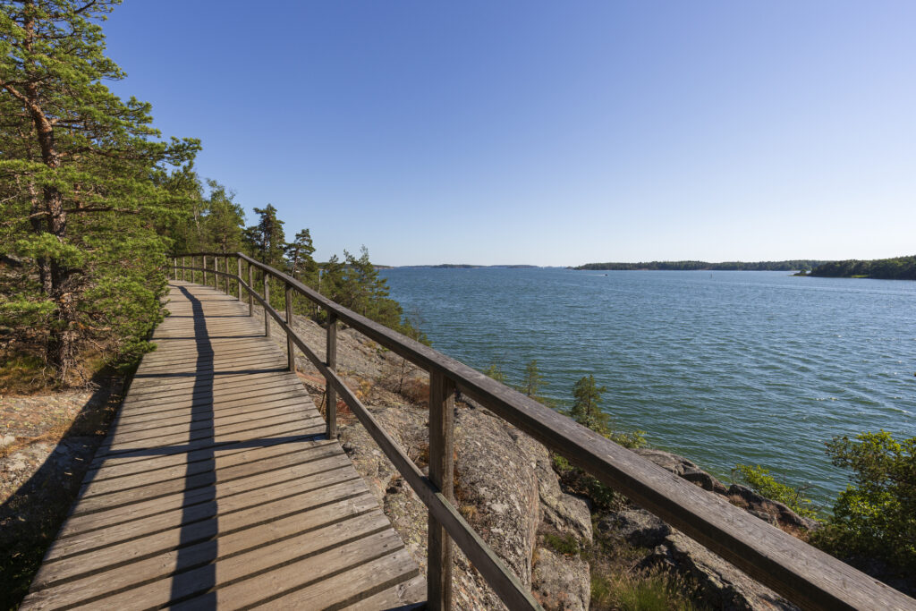 Elevated wooden seaside walkway on a cliff by the Baltic sea in Mariehamn, &Aring;land Islands, Finland, on a sunny day in the summer.