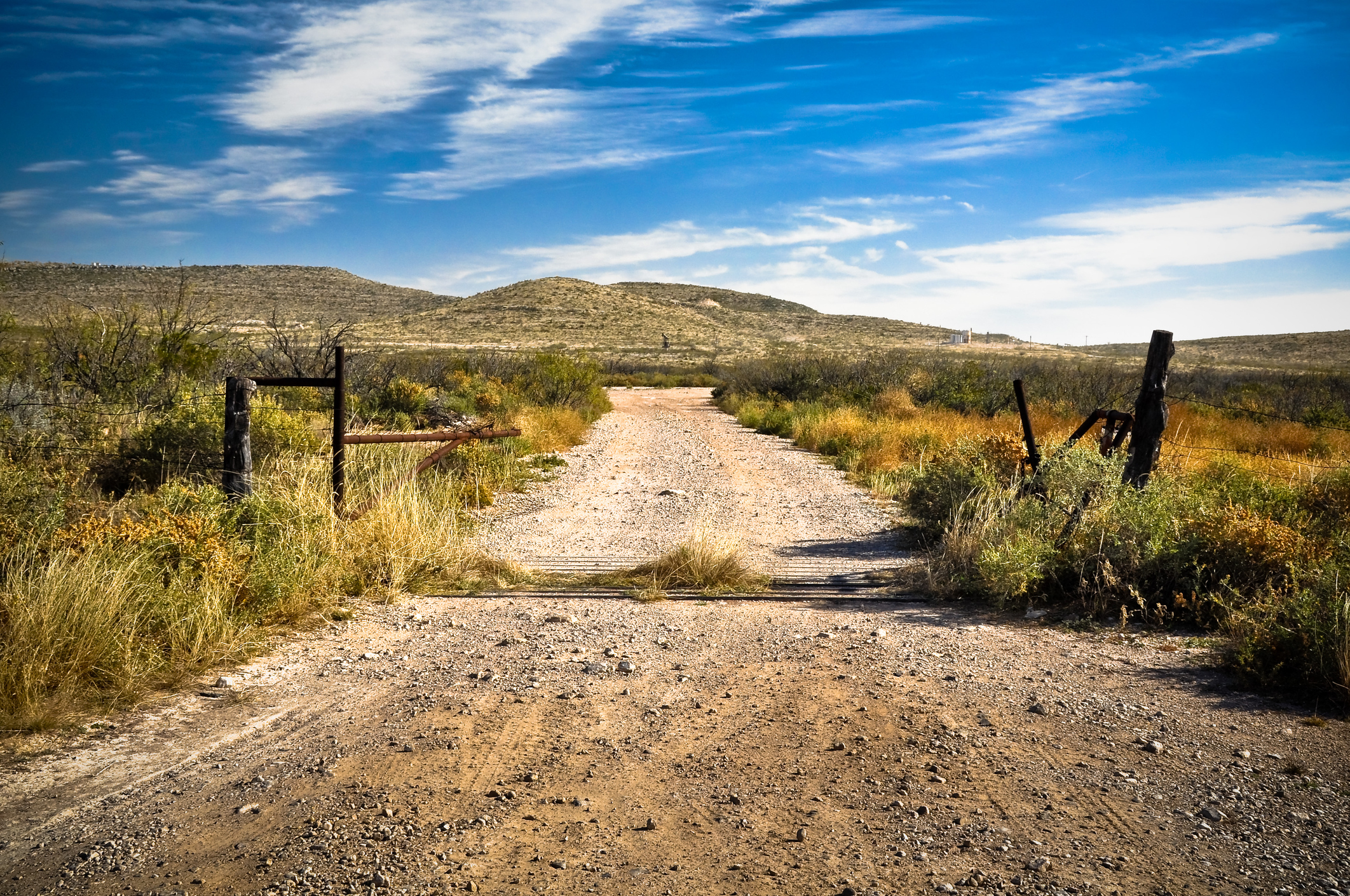 Dirt road in Texas leading through the rural landscape