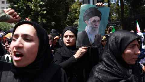 Iranians hold a portrait of Iranian Supreme Leader Ayatollah Ali Khamenei during an anti-Israel rally in Tehran