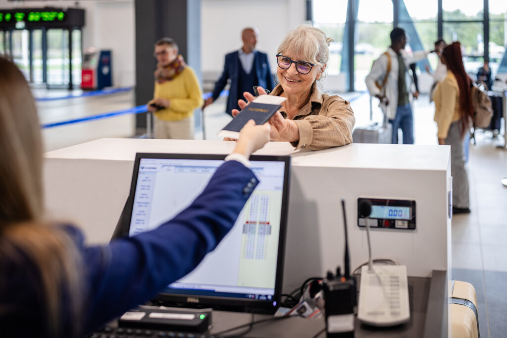 Woman receives passport back at airport counter