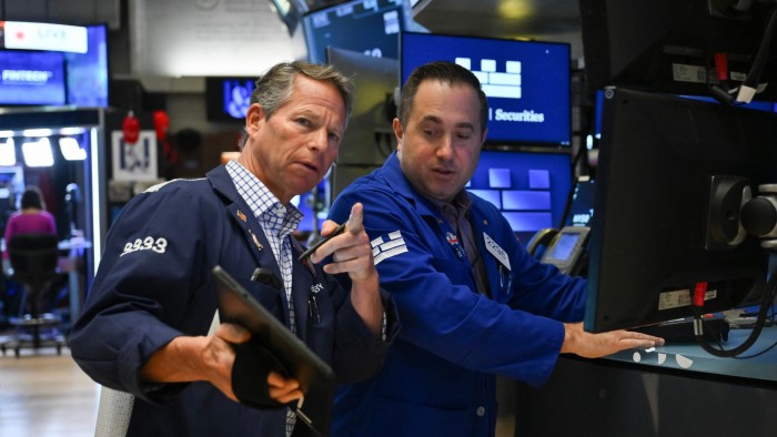 Traders work on the floor of the New York Stock Exchange