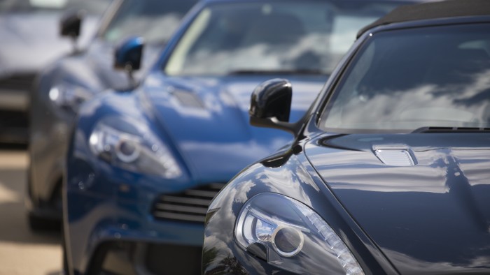 Aston Martin Lagondas on display outside a showroom