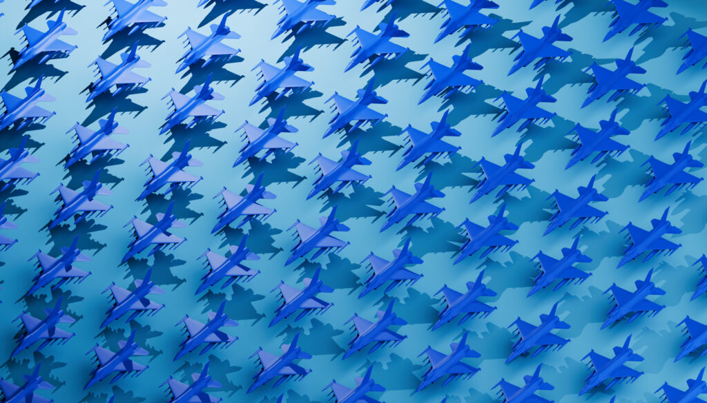 small models of blue jet fighter planes lined up in neat rows with a teal background