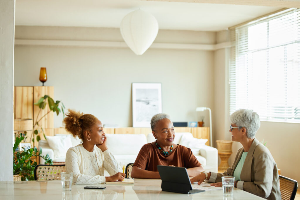 Financial adviser discussing finance with women at home