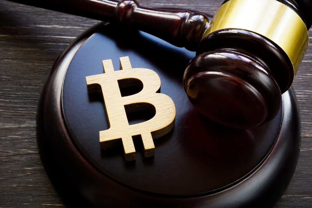 A bitcoin symbol on a gavel to symbolize cryptocurrency regulation.