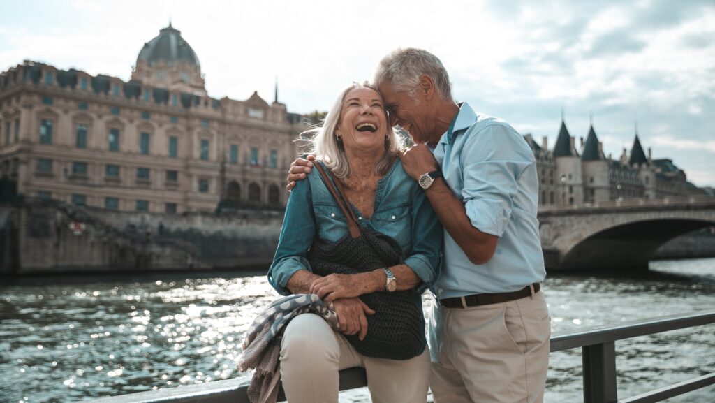 A retired couple smiling on vacation.