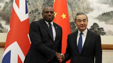 Britain’s Foreign Secretary David Lammy and Chinese Foreign Minister Wang Yi shake hands before their meeting at the Diaoyutai State Guesthouse in Beijing