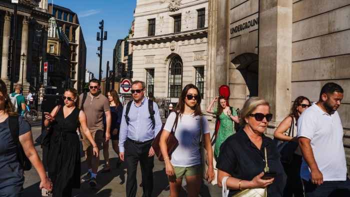City workers pass the Bank of England