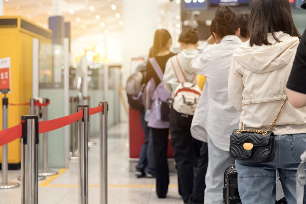 Travelers waiting in line at the airport.