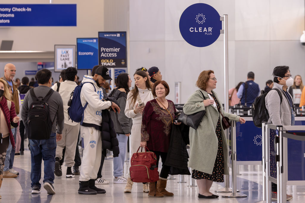 Passengers stand in Clear Plus line that gets them to their gate faster, using their eyes or fingerprints to verification, at Los Angeles International Airport.