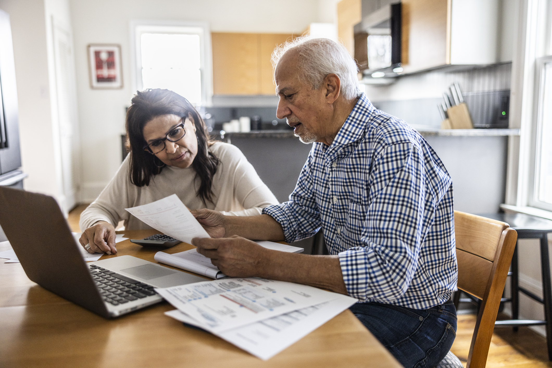 A couple sitting at a table discussing personal finance