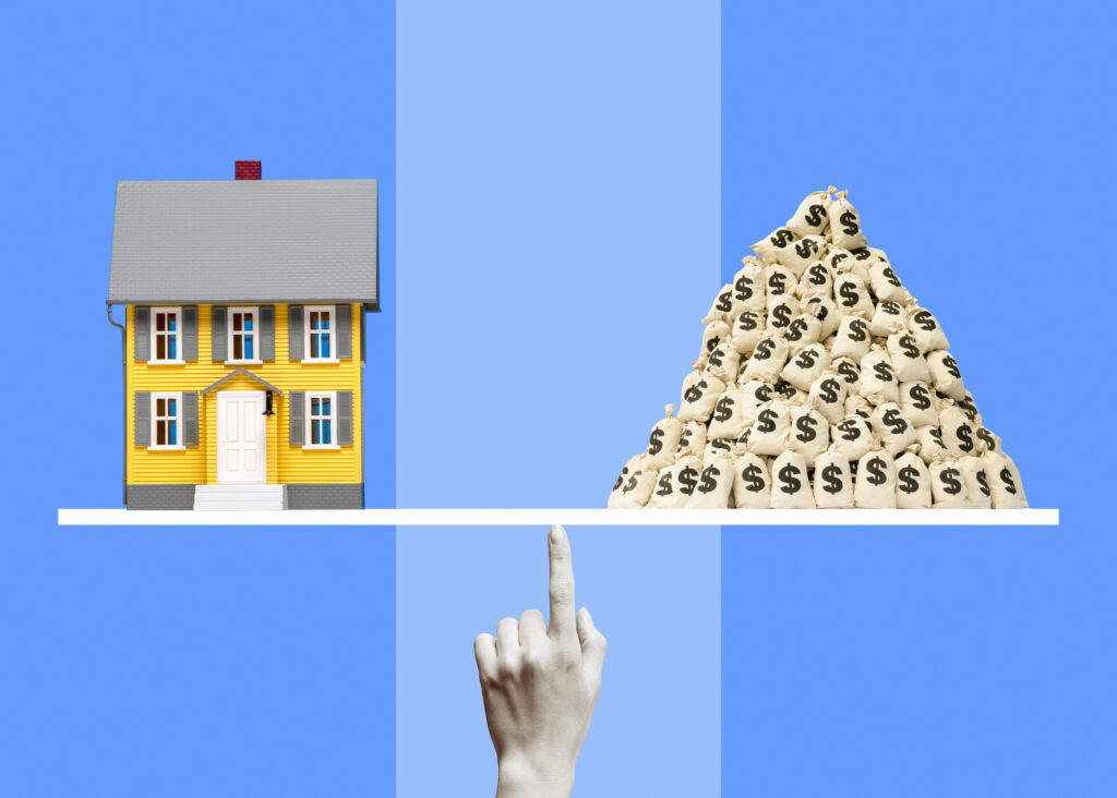 A house balancing against a large pile of money