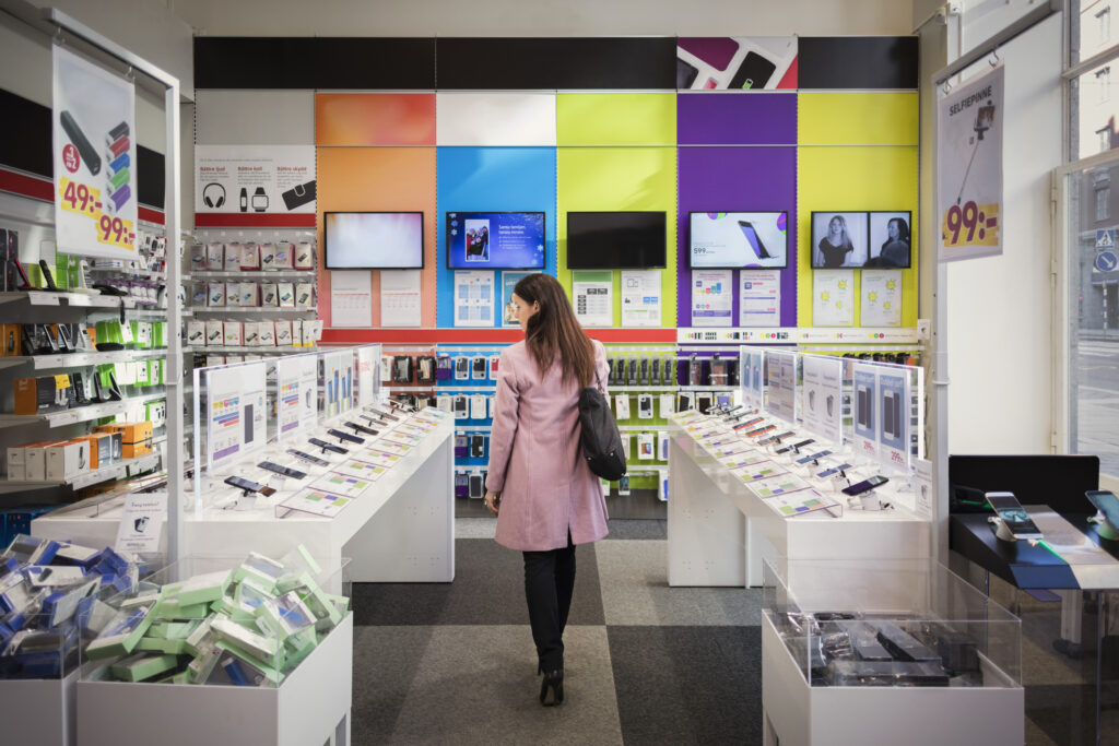 Customer viewing electronics and smart phones in store