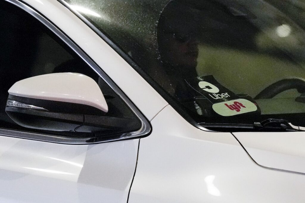 Uber and Lyft stickers are seen on a ride share vehicle is seen at the Nashville International Airport, Friday, Aug. 30, 2024, in Nashville, Tenn. (AP Photo/George Walker IV)