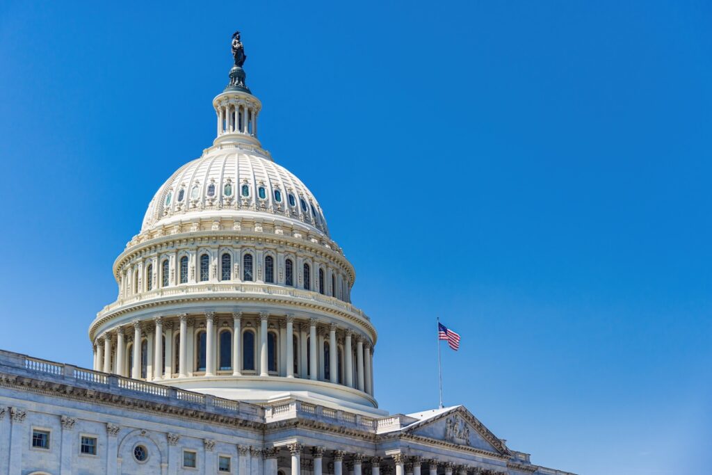 The United States Capitol building with American flag | Source: The College Investor