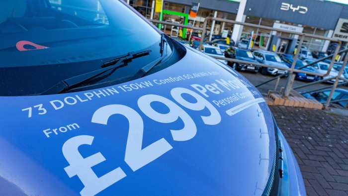 Monthly price displayed on the bonnet of a vehicle for sale on the forecourt of a car dealership in Scotland