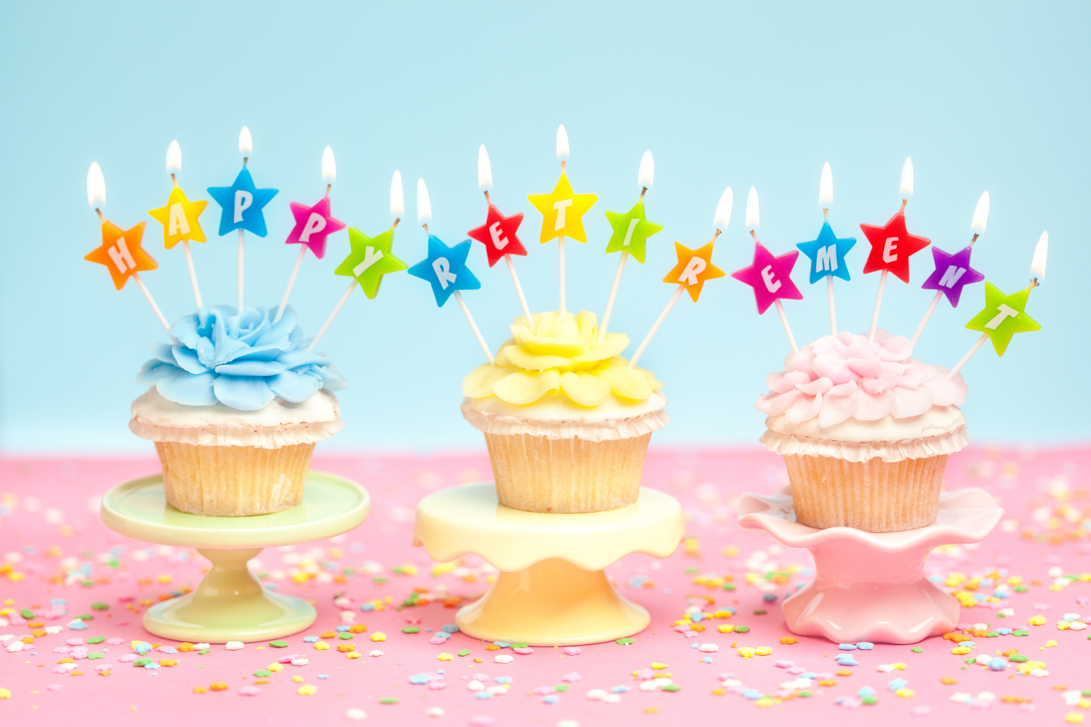 Buttercream frosting cupcakes on a cake stands with retirement candles in celebration party.
