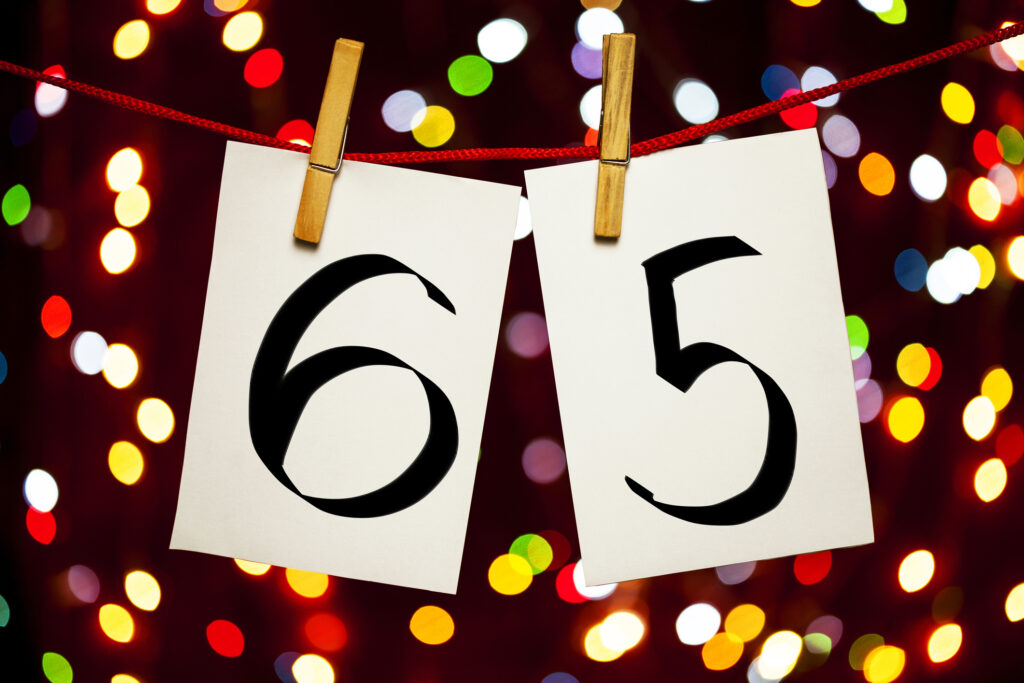 the number 65 on clothespins hanging on a line