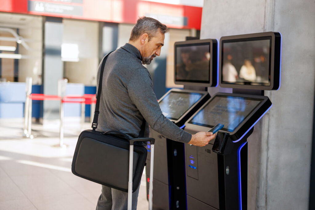 Traveler uses digital kiosk at airport