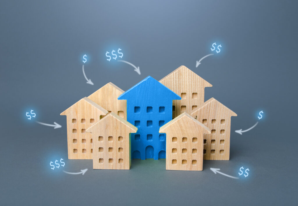 group of wooden houses with dollar signs above them