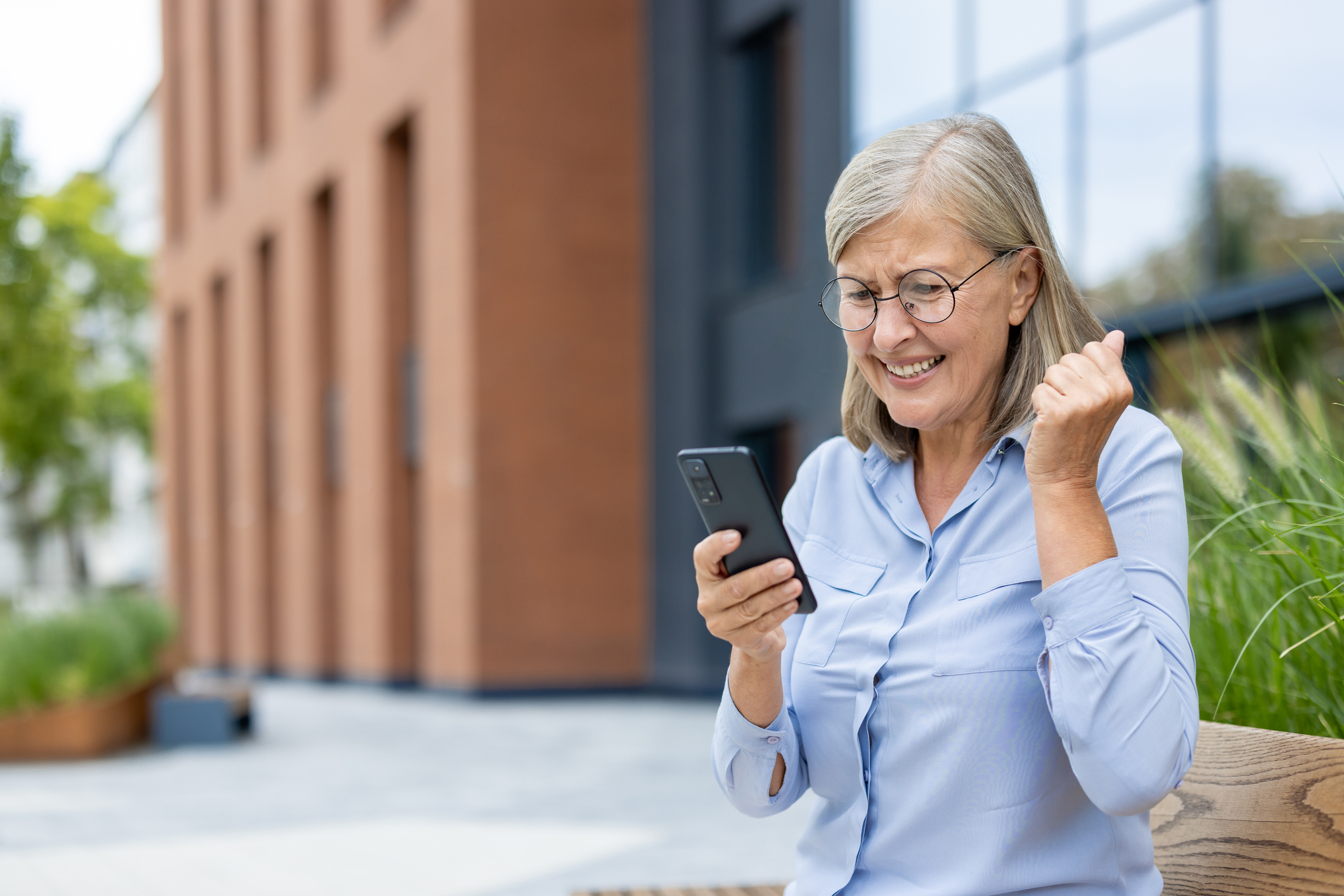 an excited woman reading her phone