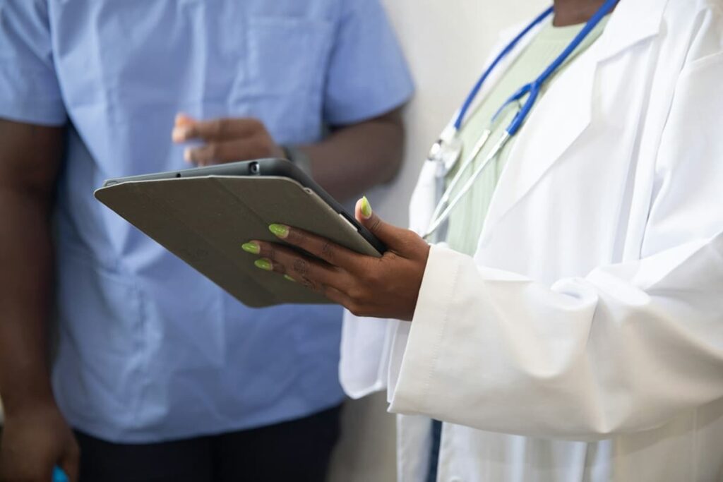 doctor showing healthcare records with patient