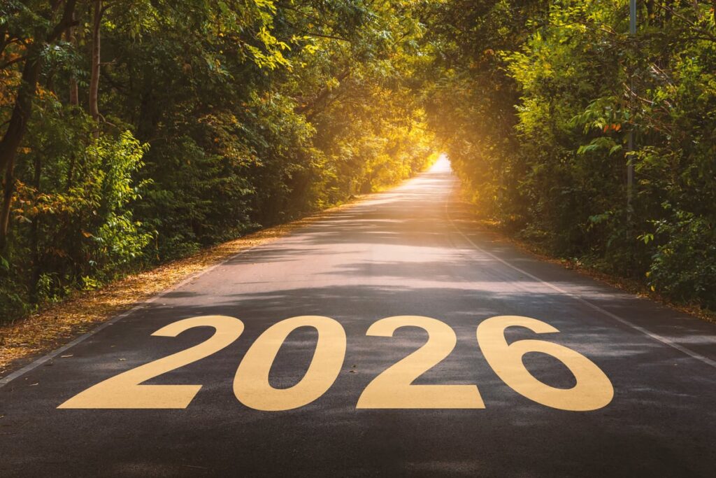 A paved road through the countryside is shown with the year 2026 written on it.