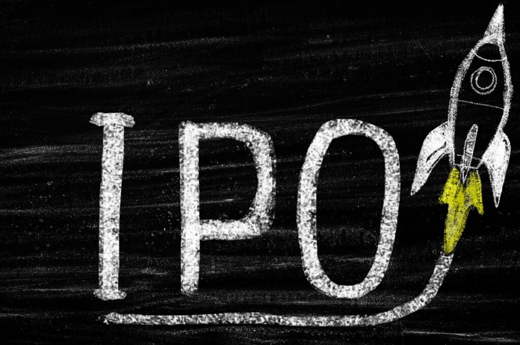 Chalkboard drawing of a rocket ship going up and the letters IPO.
